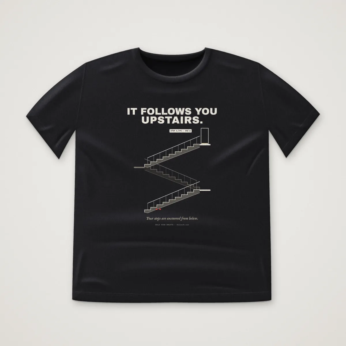 IT FOLLOWS YOU UPSTAIRS. Tee in Black, front